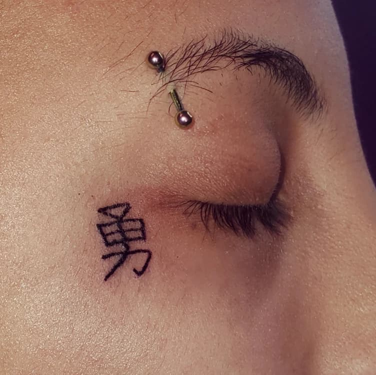 Face tattoo and eyebrow piercing by Tatt2 Therapy, Newark NJ